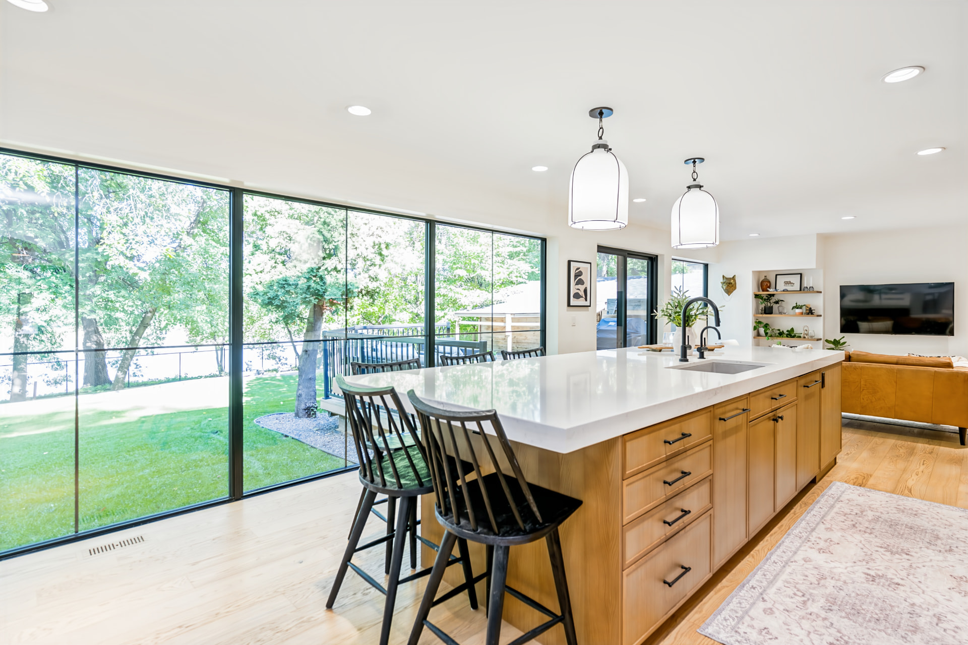 Kitchen island with floor-to-ceiling windows overlooking the backyard and Red River