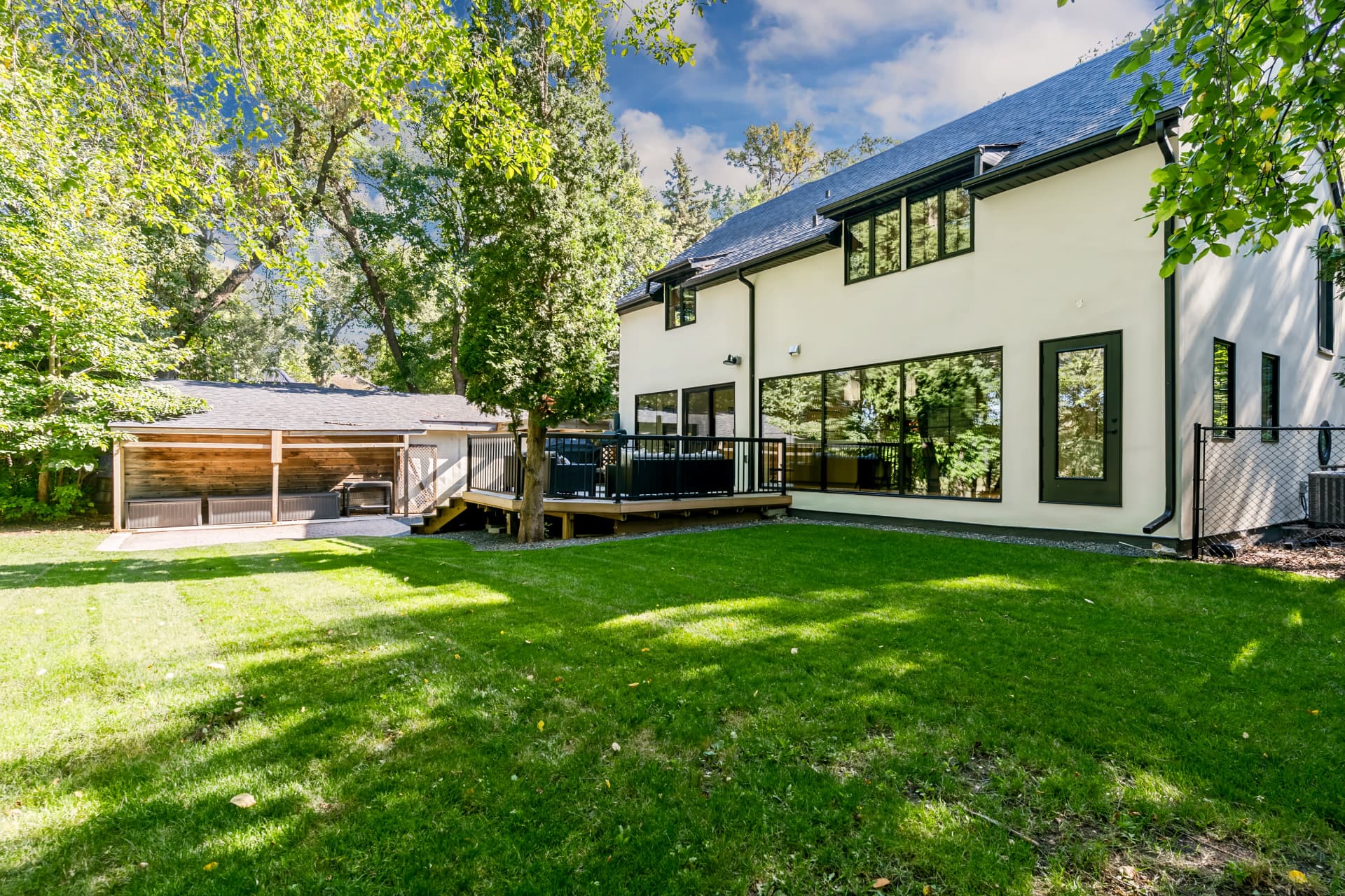 Backyard lawn running down to the Red River, framed by mature trees