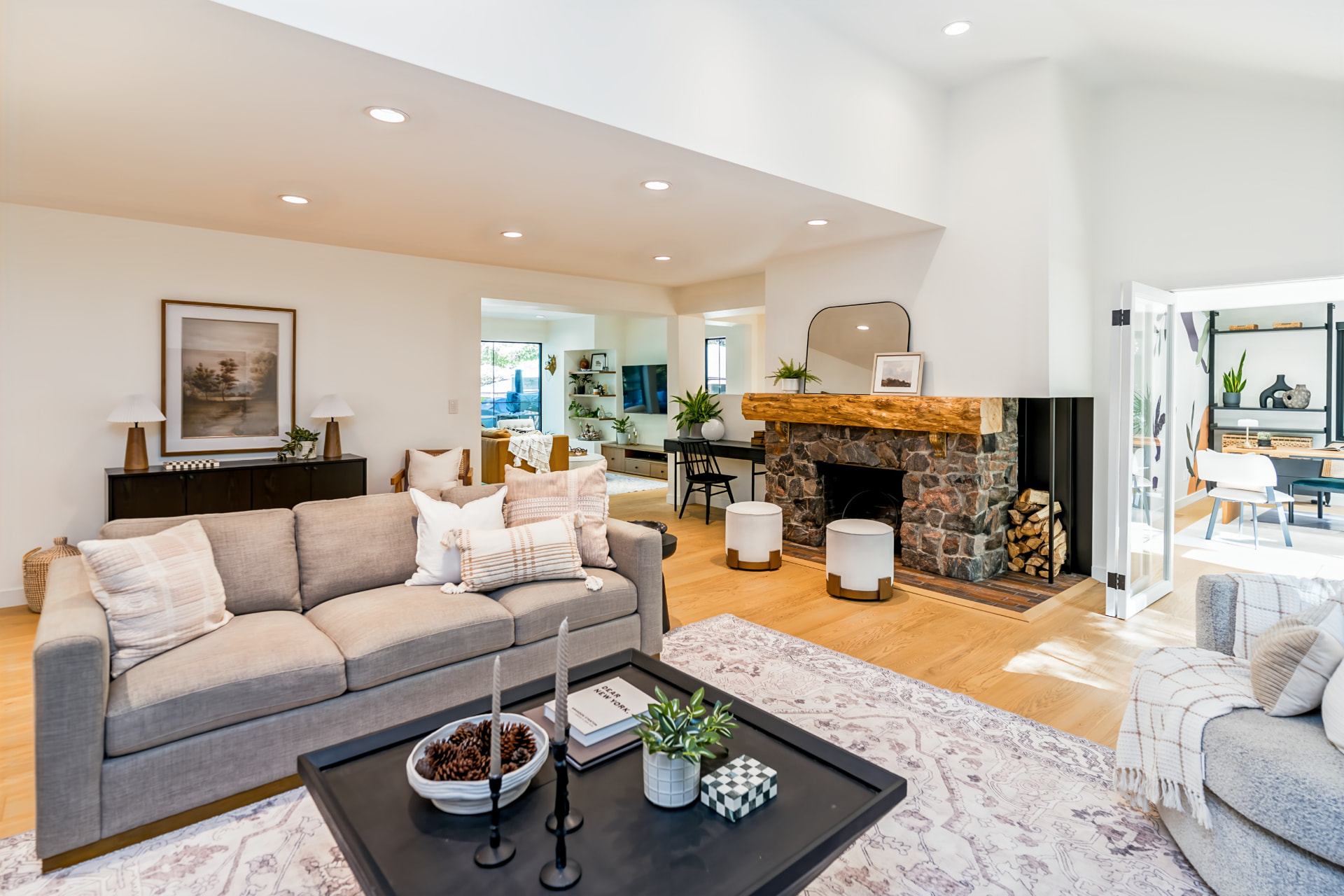 Oversized living room with original stone fireplace and custom wood mantle