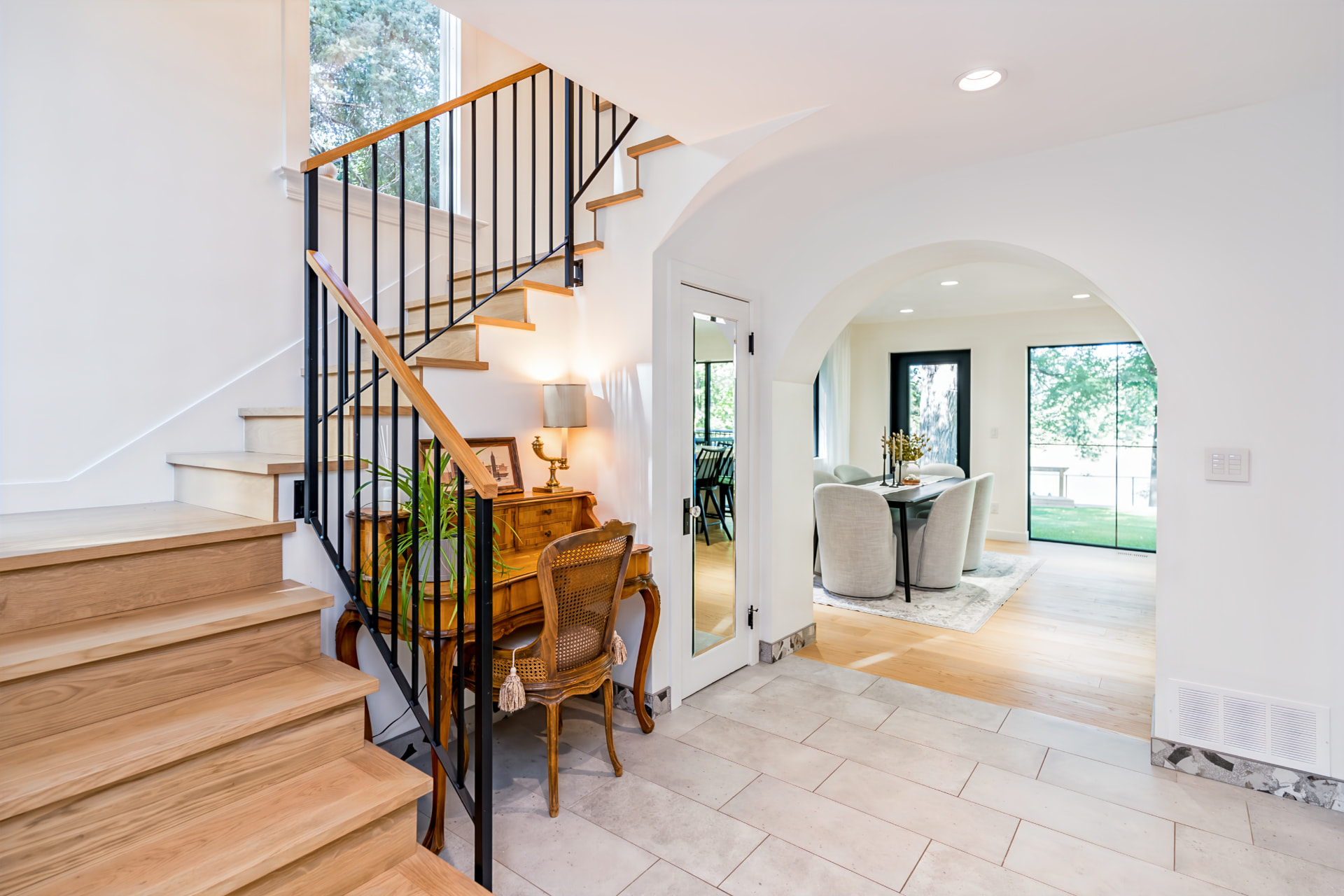 Rebuilt staircase with custom ornamental bannister beside the dining room