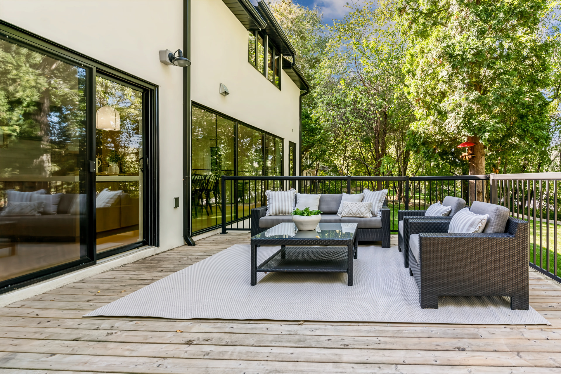 Large rear deck surrounded by mature trees